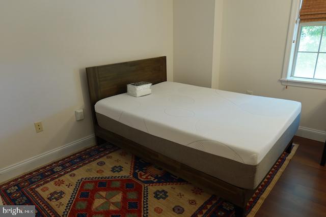 2151 Jamieson Avenue, Unit 411 Alexandria, VA 22314 - Photo 19 of 32 a bed sitting in a bedroom next to a window