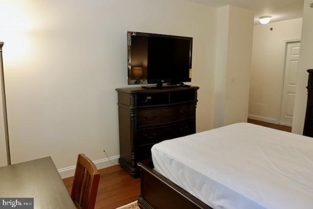 2151 Jamieson Avenue, Unit 411 Alexandria, VA 22314 - Photo 23 of 32 a bedroom with a bed and a flat screen tv