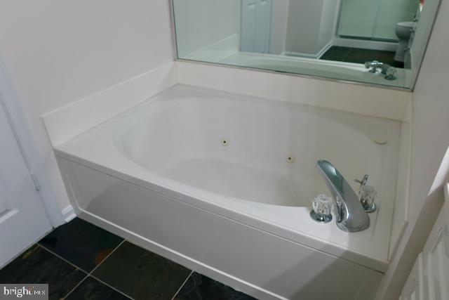 2151 Jamieson Avenue, Unit 411 Alexandria, VA 22314 - Photo 25 of 32 a bathroom with a bathtub