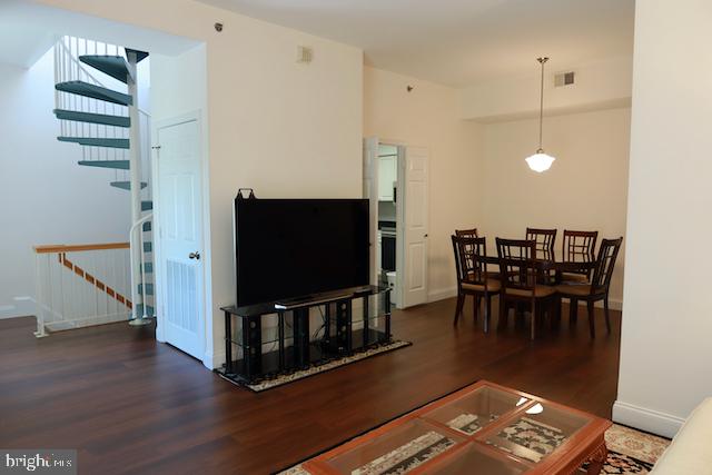 2151 Jamieson Avenue, Unit 411 Alexandria, VA 22314 - Photo 5 of 32 a living room with furniture and a flat screen tv