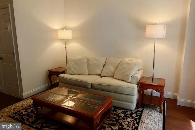 a living room with furniture and a lamp