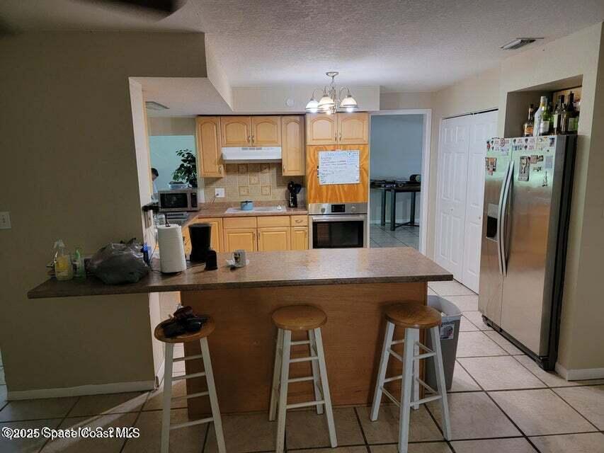 200 Southgate Boulevard Melbourne, FL 32901 - Photo 3 of 9 a kitchen with a table and chairs in it