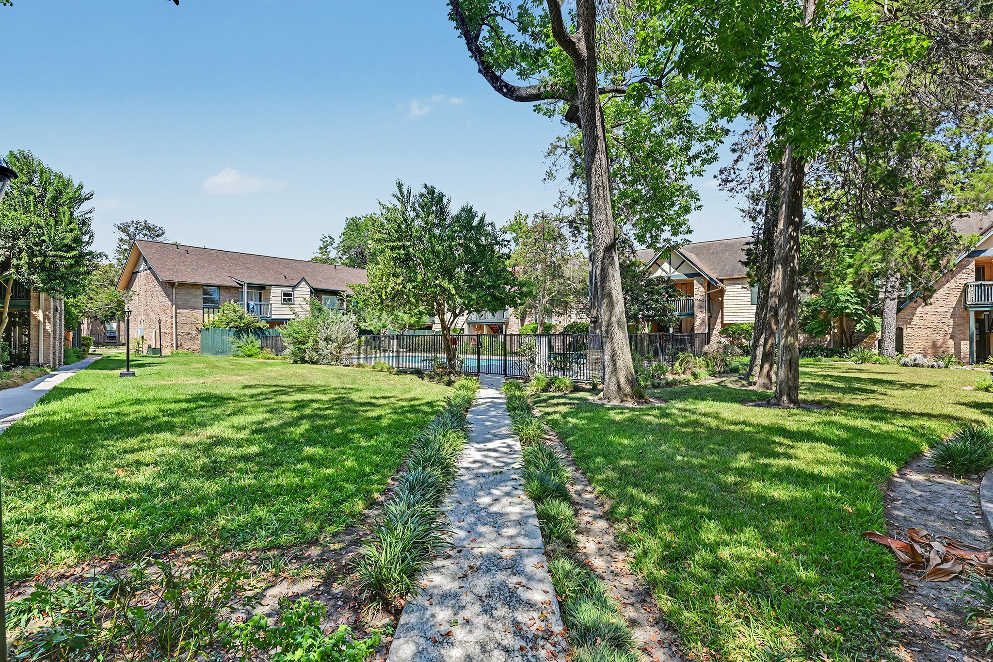 8211 Kingsbrook Road, Unit 205 Houston, TX 77024 - Photo 18 of 23 The grounds. The pool area is enclosed.