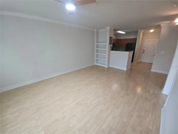 a view of empty room with wooden floor