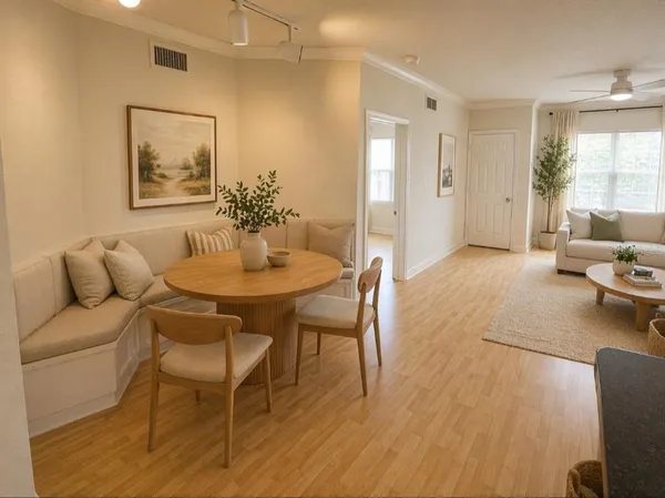 a living room with furniture and a wooden floor