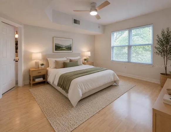 a bedroom with a bed and a large window