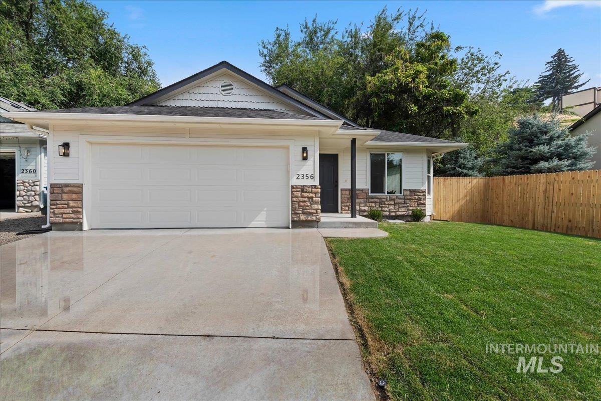 2356 West Hill Road Boise, ID 83702 - Photo 2 of 22 Contemporary exterior featuring horizontal siding, stone veneer accents, and a large front-facing garage
