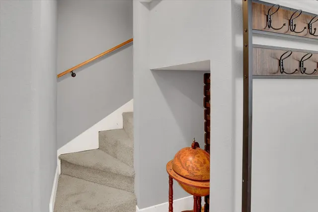 a living room with table and entryway