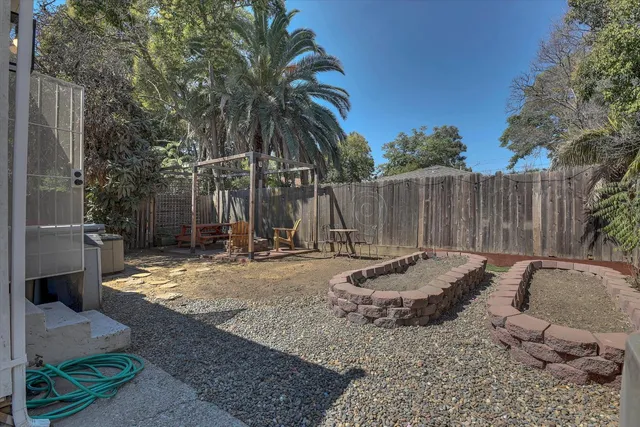 a backyard of a house with barbeque oven and outdoor seating