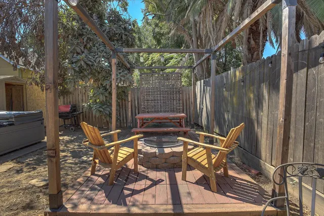 a view of backyard with outdoor seating and trees