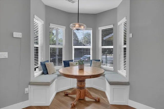 a dining room with furniture and window