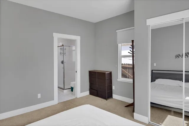 a bedroom with a bed and cabinets