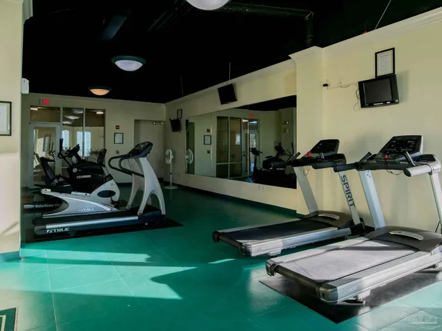 a room with gym equipment and a flat screen tv