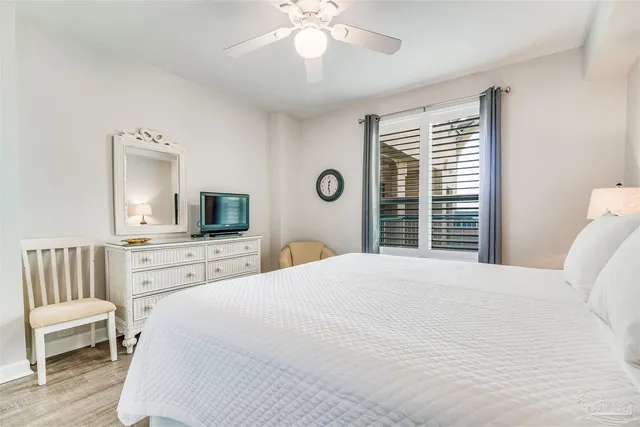 a bedroom with a large bed and a flat screen tv