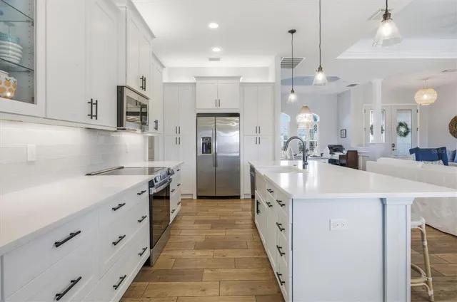 a view of a dining room with furniture a chandelier and wooden floor