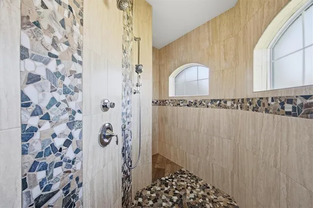 a living room with furniture and a floor to ceiling window