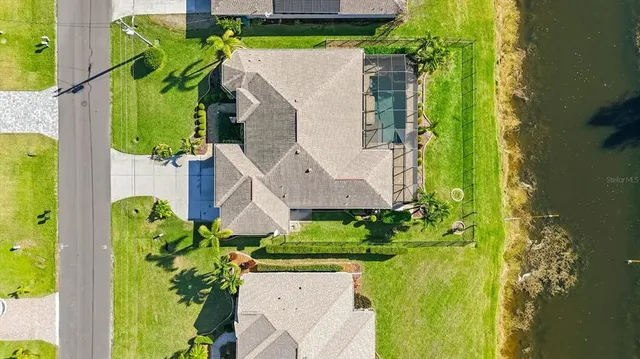 a view of a lake with a swimming pool and outdoor seating