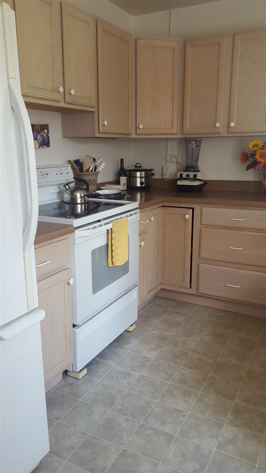 837 26 Road Grand Junction, CO 81505 - Photo 12 of 38 a kitchen with white cabinets and white appliances