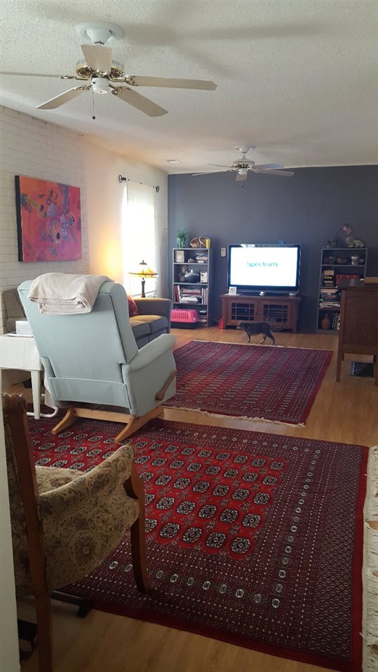 837 26 Road Grand Junction, CO 81505 - Photo 2 of 38 a living room with furniture and a flat screen tv