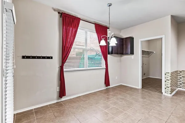 a view of a room with window and a ceiling fan