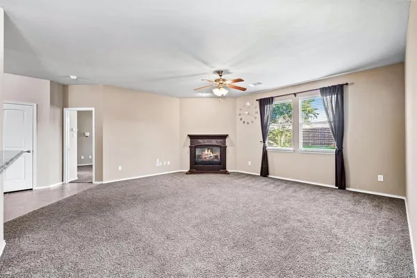 a view of an empty room with a fireplace