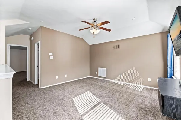 a view of a livingroom with a ceiling fan and entryway