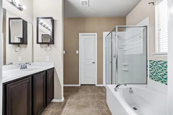 a bathroom with a bathtub and a sink