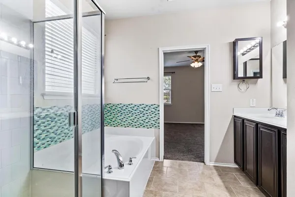 a bathroom with a tub and shower