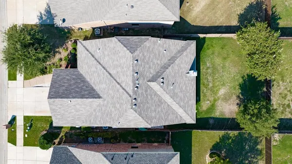 an aerial view of a house with a yard