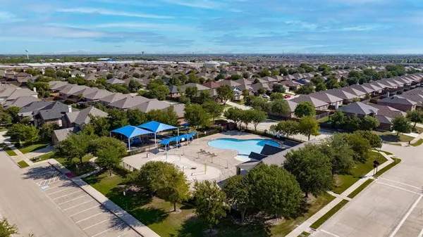 an aerial view of residential houses with outdoor space