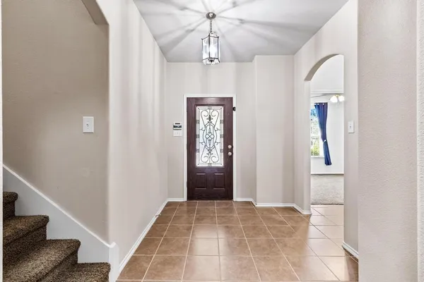 a view of an entryway with chandelier