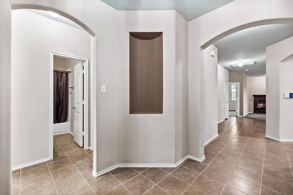 a view of a hallway with wooden floor and a living room
