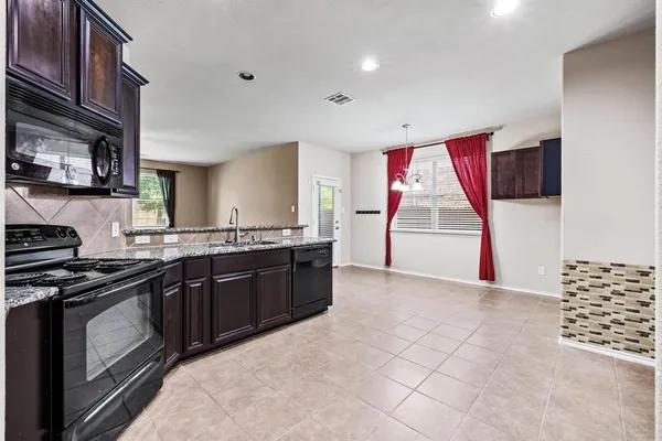 a kitchen with stainless steel appliances granite countertop a stove and a sink