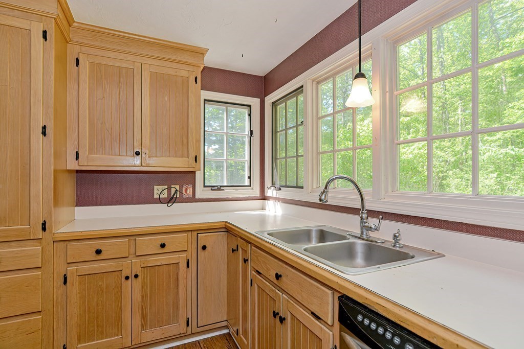 111 Center Depot Road Charlton, MA 01507 - Photo 5 of 42 a kitchen with a sink cabinets and a large window
