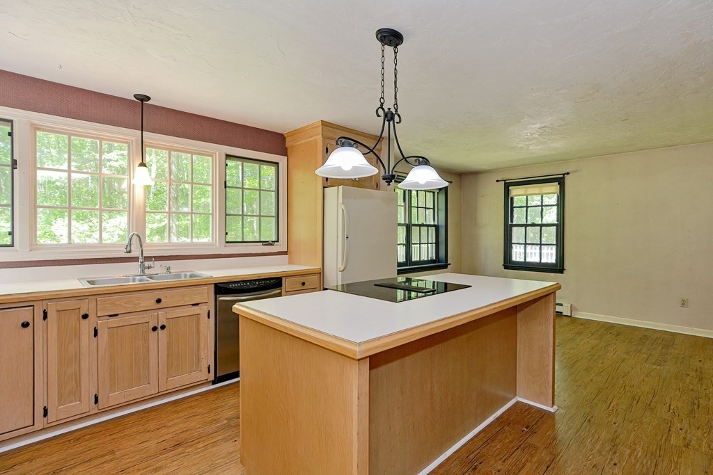 111 Center Depot Road Charlton, MA 01507 - Photo 6 of 42 a kitchen that has a sink a stove and a wooden floor