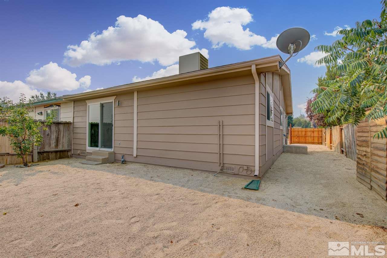 6755 Lotus Street Reno, NV 89506 - Photo 24 of 27 a front view of a house with a yard and garage