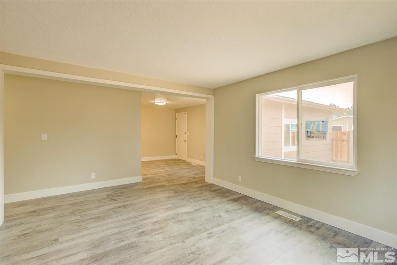 6755 Lotus Street Reno, NV 89506 - Photo 4 of 27 a view of an empty room with wooden floor and a window