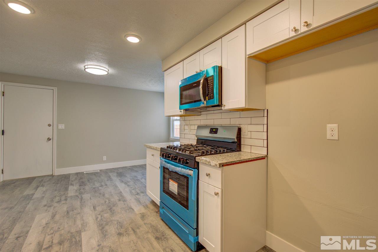 6755 Lotus Street Reno, NV 89506 - Photo 6 of 27 a kitchen with a stove and a microwave