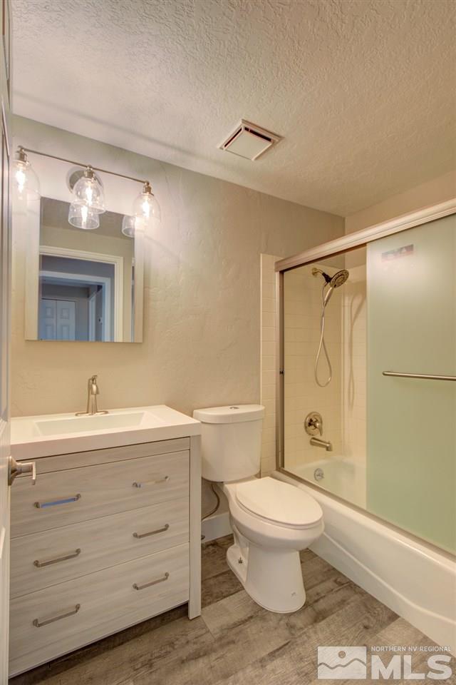 6755 Lotus Street Reno, NV 89506 - Photo 7 of 27 a bathroom with a sink a toilet and shower