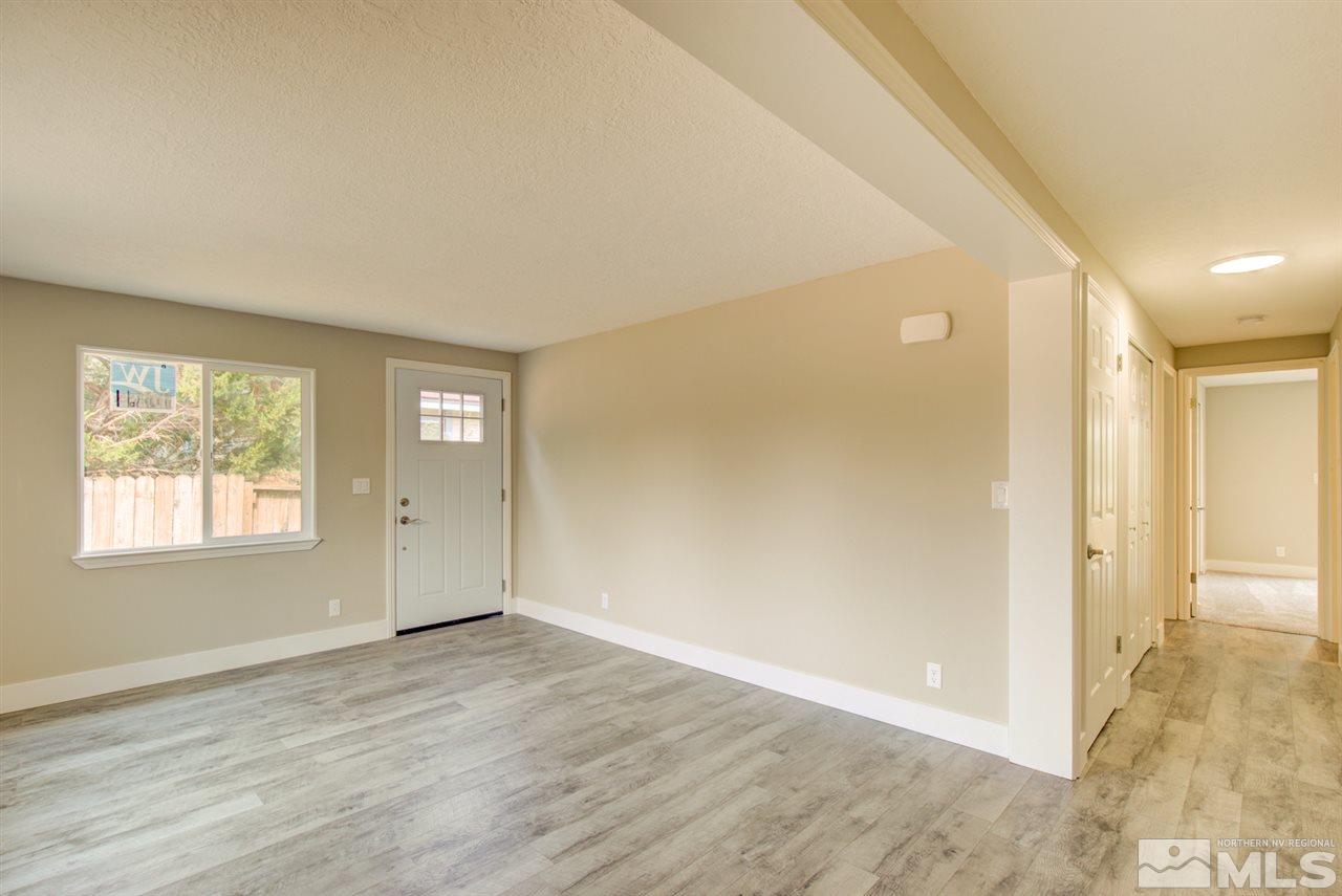 6755 Lotus Street Reno, NV 89506 - Photo 10 of 27 an empty room with wooden floor and windows