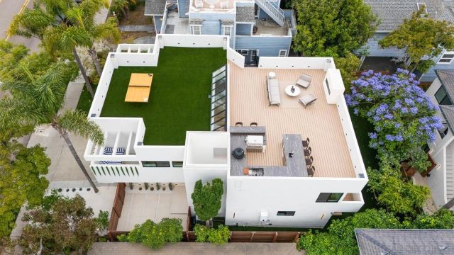 a living room with furniture and large windows
