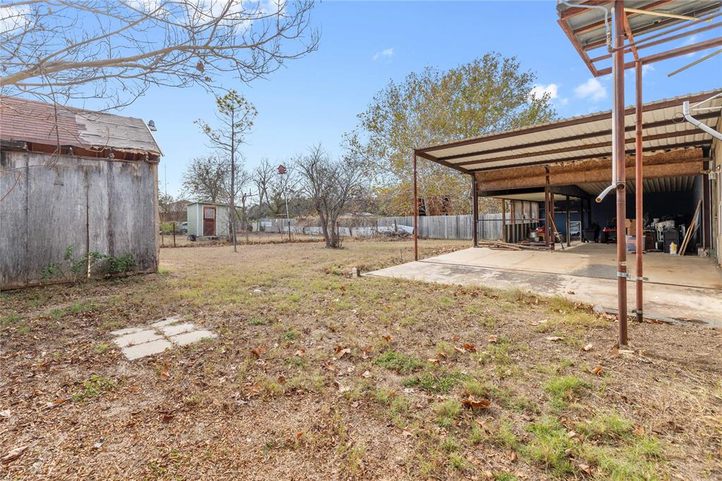 309 Goodwin Street Bangs, TX 76823 - Photo 17 of 20 View of yard with an outdoor structure and a patio area