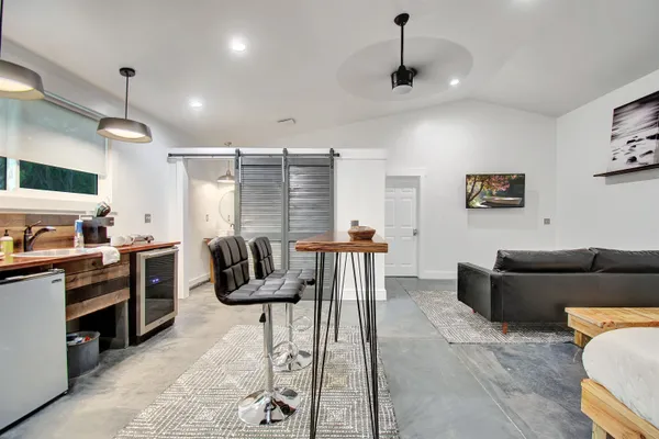 a kitchen with stainless steel appliances kitchen island granite countertop a refrigerator and a stove top oven