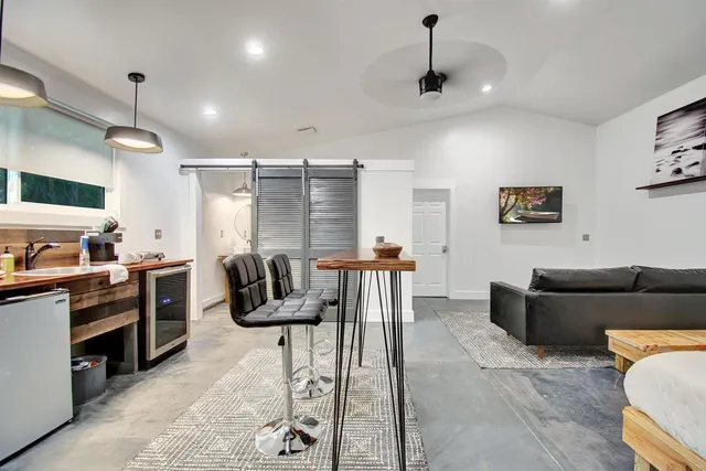 a kitchen with stainless steel appliances kitchen island granite countertop a refrigerator and a stove top oven