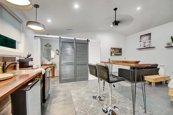 a kitchen with stainless steel appliances granite countertop a sink a stove and a refrigerator