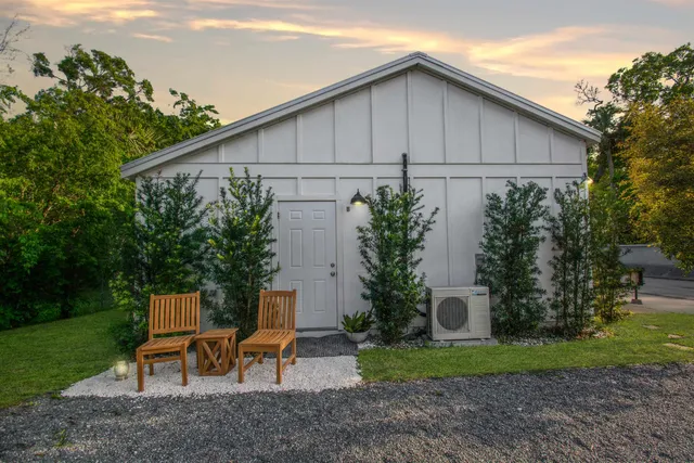 a backyard of a house with wooden fence and plants