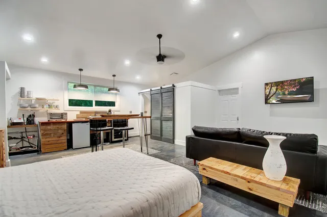 a large bedroom with furniture and a flat screen tv