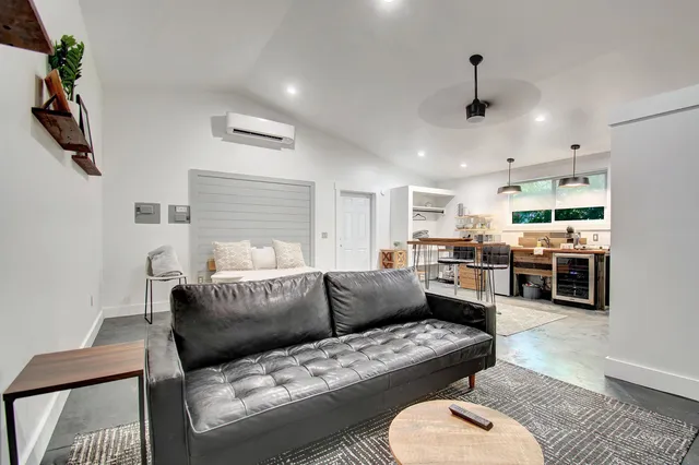a living room with furniture kitchen view and a couch