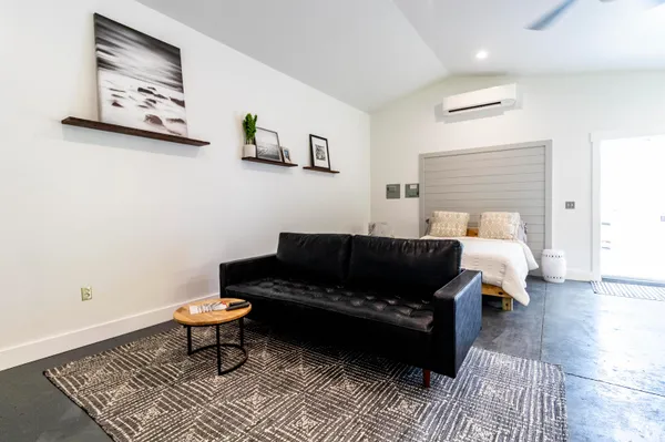 a living room with furniture and a rug
