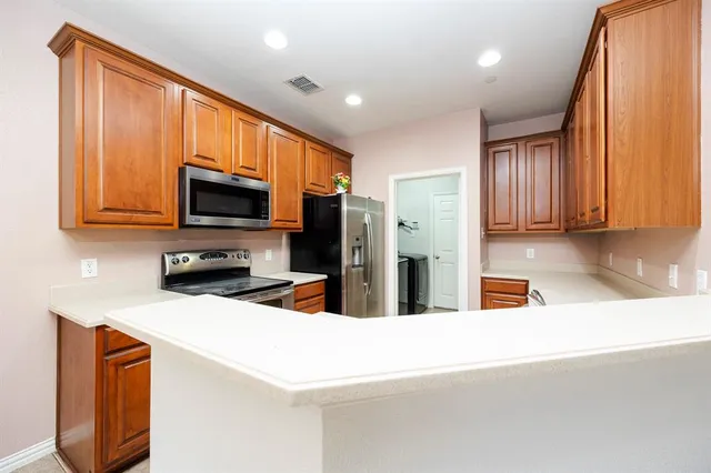 a kitchen with stainless steel appliances a refrigerator and a sink